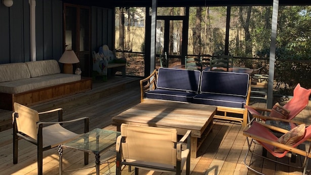 A covered outdoor seating area with wooden flooring, cushioned seating, and a glass ceiling. - Middlesex Beach - Sunday to Sunday summer rentals.  Private community beach.  (Bethany Beach)