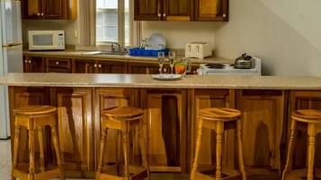 Fridge, microwave, stovetop, cookware/dishes/utensils