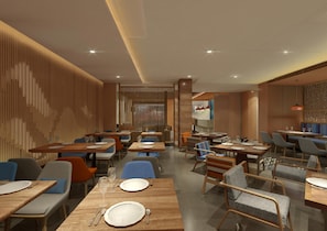 A modern restaurant interior with multiple dining tables and chairs, wooden paneling on the walls, and recessed ceiling lighting.