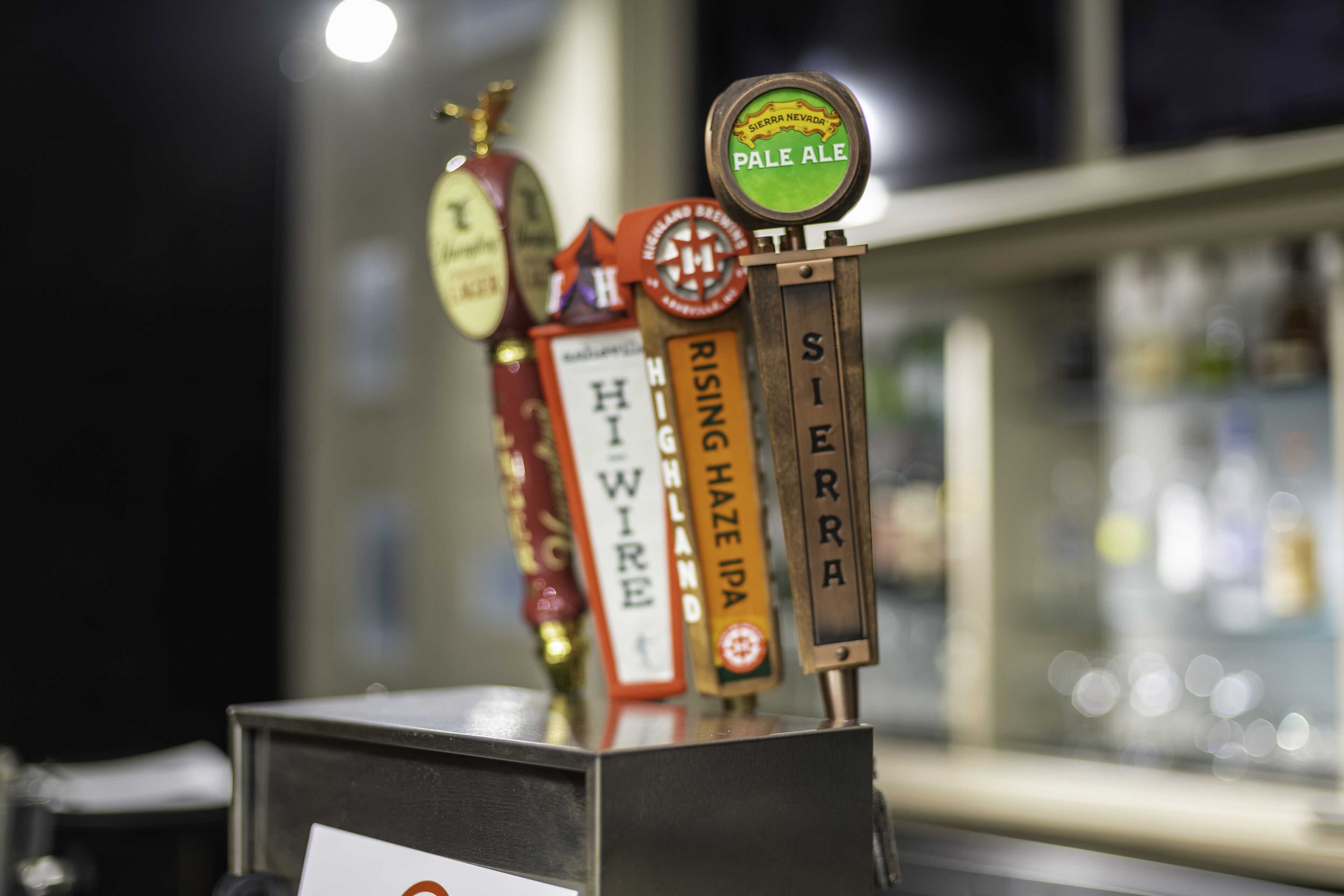 Ein Zapfhahn-Display mit Beschriftungen für verschiedene Biersorten, darunter Pale Ale und Sierra Nevada.