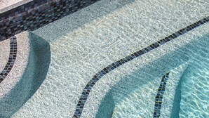 A pool with clear water and a tiled edge. - Vue Broadbeach (Broadbeach)