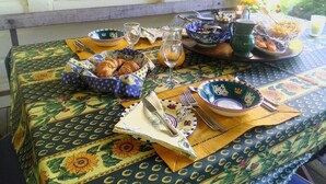 A table set with breakfast items, including croissants, fruit, and a glass of orange juice. - Mairenui Rural Retreat (Rangiwahia)