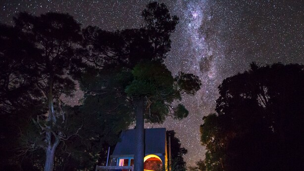 A house with a visible balcony and a starry night sky. - Mairenui Rural Retreat (Rangiwahia)