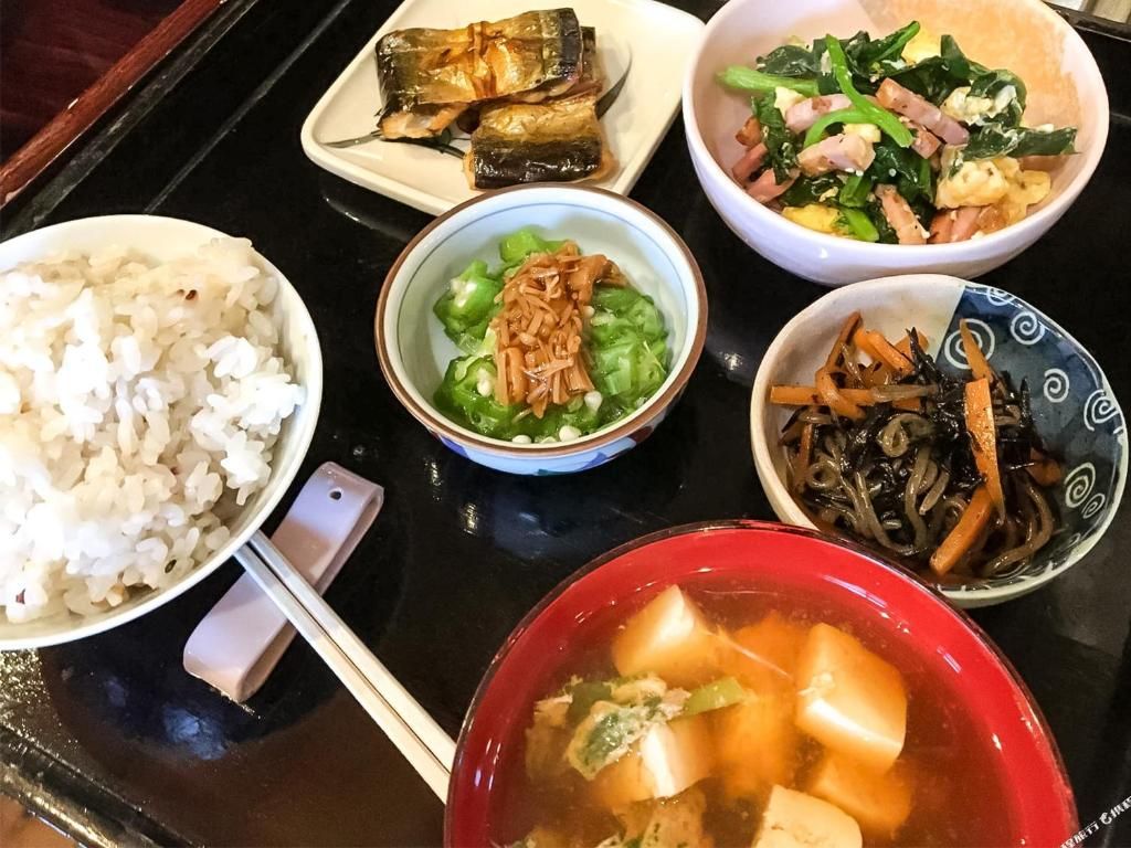 A variety of dishes including rice, vegetables, and soup, suggesting a meal setting.