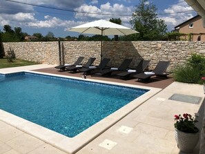 A heated pool, pool loungers