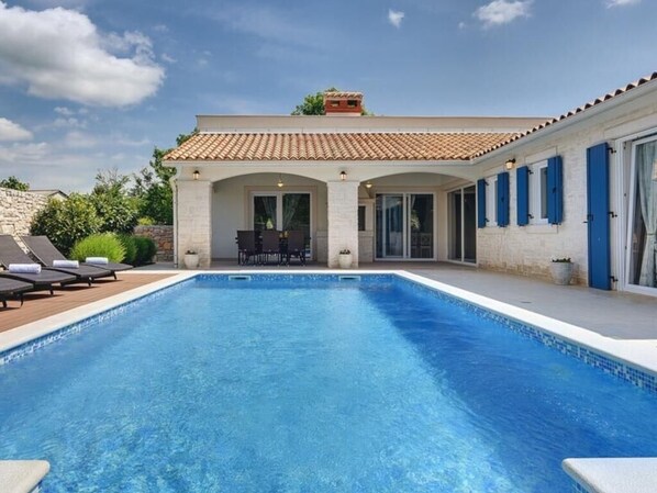 A heated pool, pool loungers
