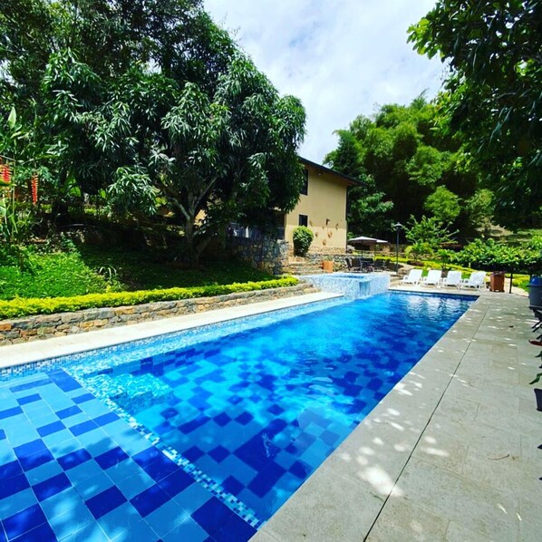 Outdoor pool, open 9:00 AM to 8:00 PM, pool umbrellas