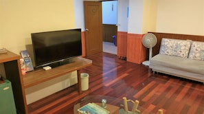 Standard Quadruple Room | Living room | 50-inch LED TV with cable channels, TV