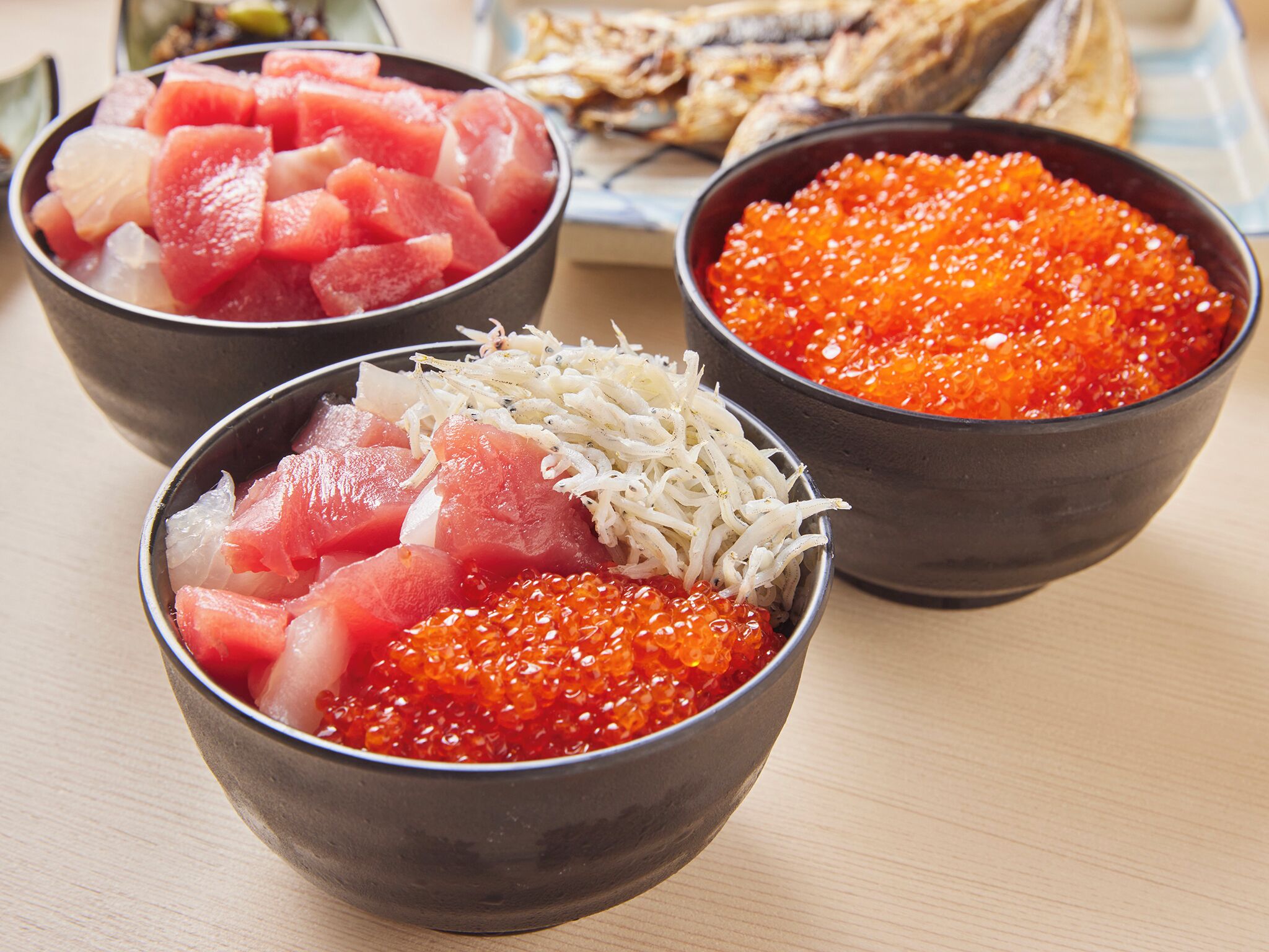 Three bowls of food with different toppings.