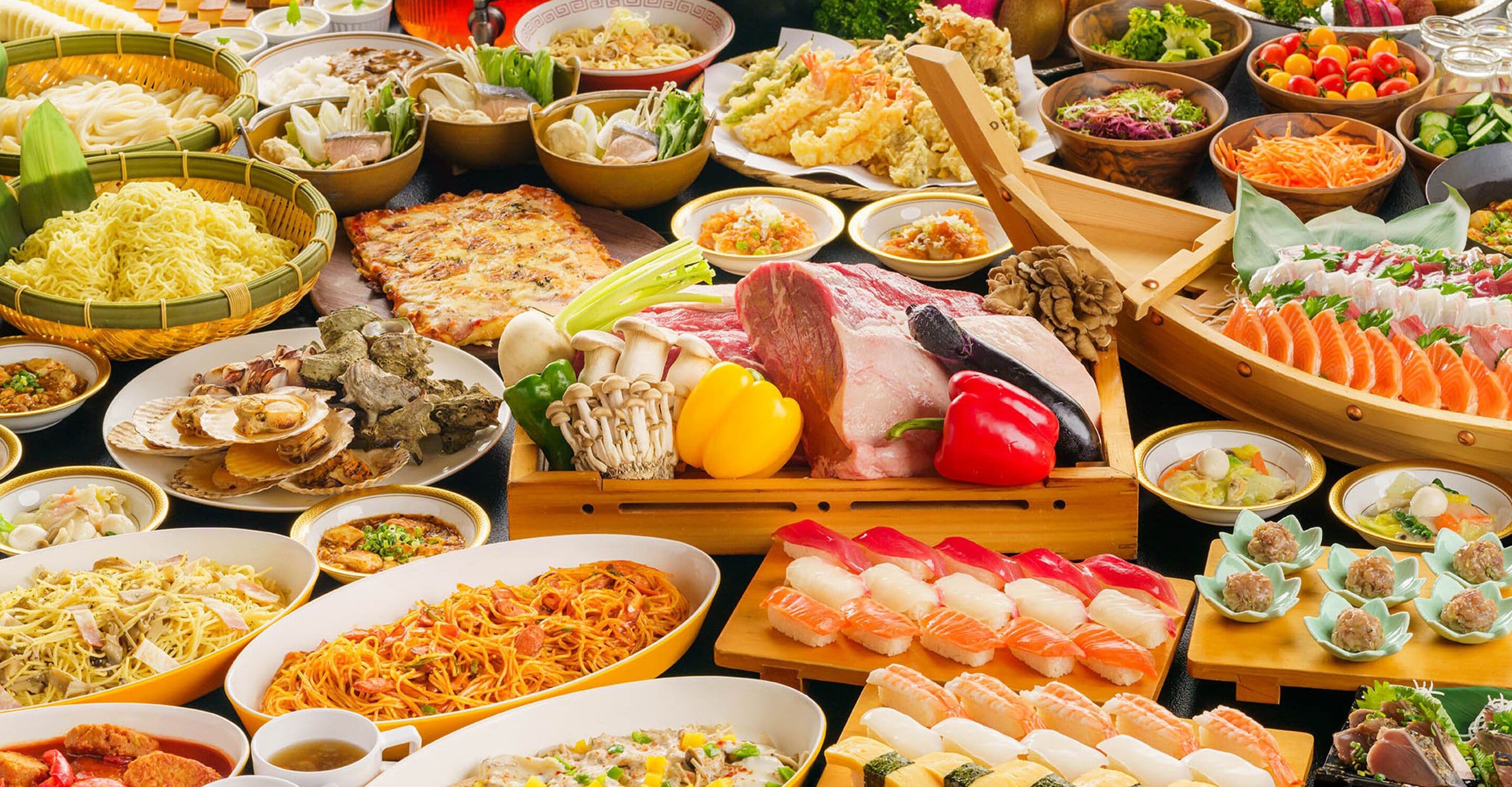 A variety of dishes including sushi, noodles, and seafood, arranged on a table.