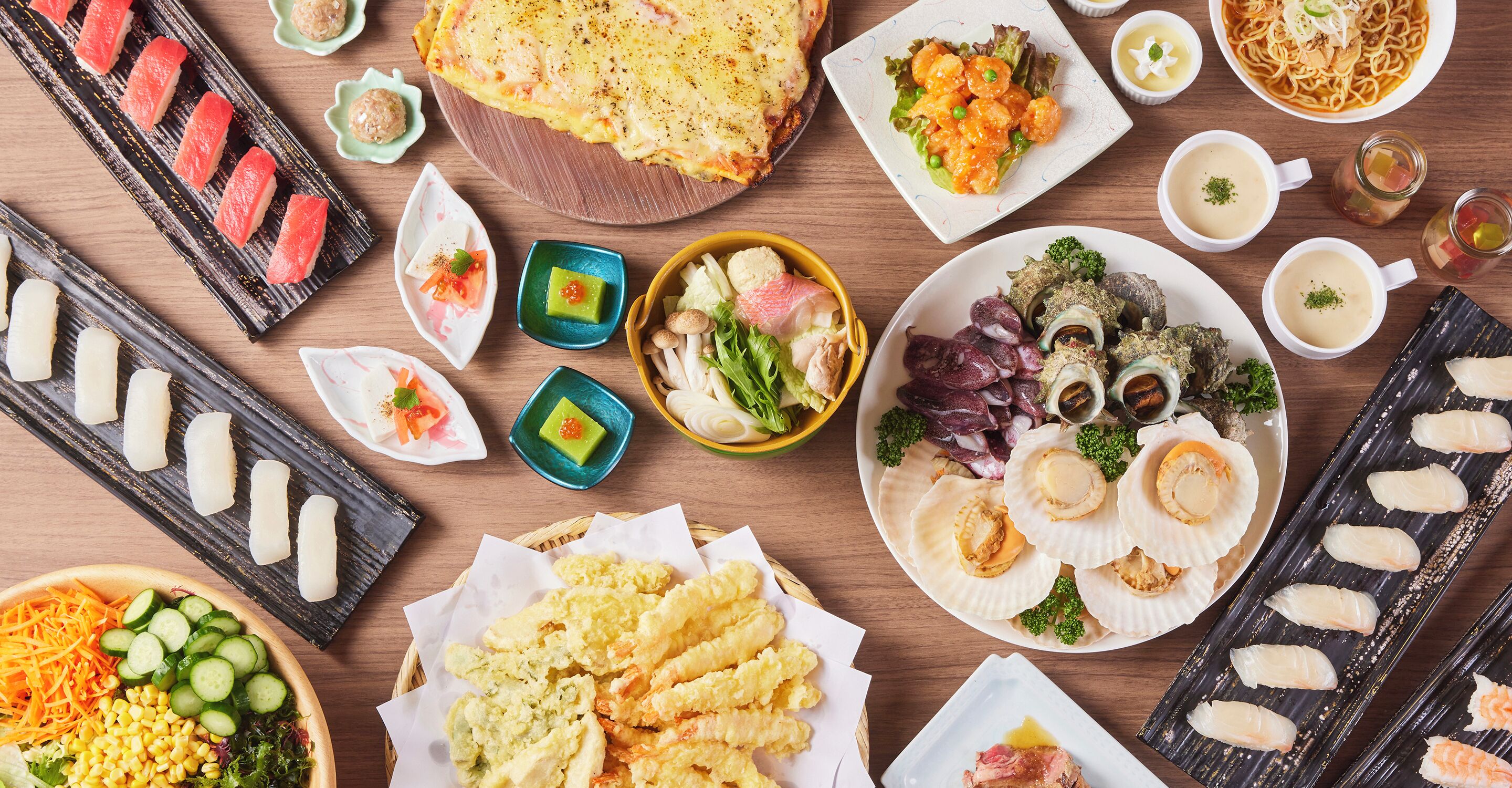 A variety of Japanese dishes including sushi, tempura, and noodles, arranged on a wooden table.