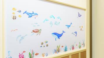 A wall with a marine-themed mural featuring various sea creatures and coral.