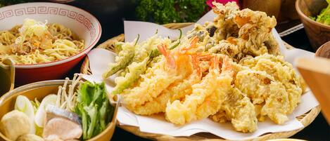 A variety of dishes including noodles, fried items, and vegetables.