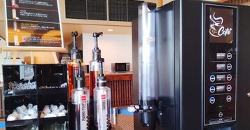 Una máquina de café con varios dispensadores y un panel con el menú.
