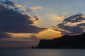 A coastal landscape with a mountain and a body of water. - Mikazuki Sea-Park Hotel Awa Kamogawa (Kamogawa)