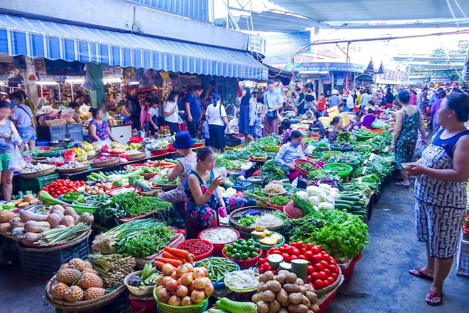 Ein belebter Markt mit verschiedenen Ständen, die frische Lebensmittel anbieten.