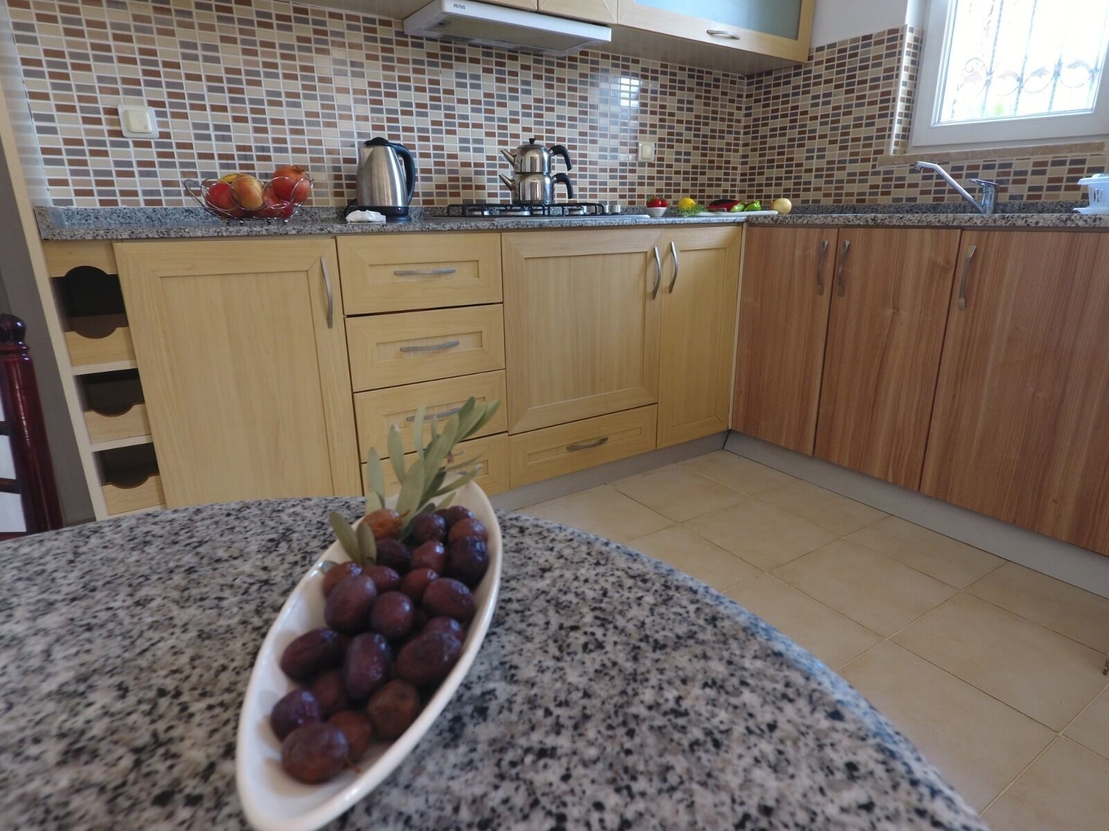 Full-sized fridge, stovetop, electric kettle, cookware/dishes/utensils