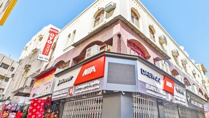 A corner building with multiple commercial signs, including NIA and Bluewater. - Oyo 393 Al Wehda Hotel (Dubai)