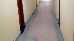 A narrow hallway with a tiled floor and light-colored walls.