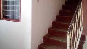 A staircase with red steps leading to a landing. - Silver Hotel Kisumu (Kisumu)