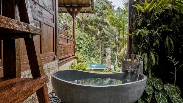 A large freestanding bathtub in a lush garden setting. - Andara Ubud Villa (Ubud)