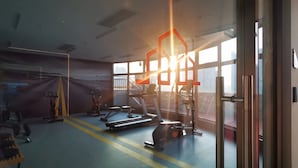 A gym with exercise equipment, large windows, and a view of the city. - LN Residence Guangzhou Changdi - Free shuttle between hotel and Exhibition Center during Canton Fair (Guangzhou)