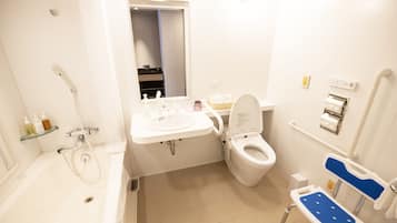 A modern bathroom with a bathtub, a sink, a toilet, and a shower.