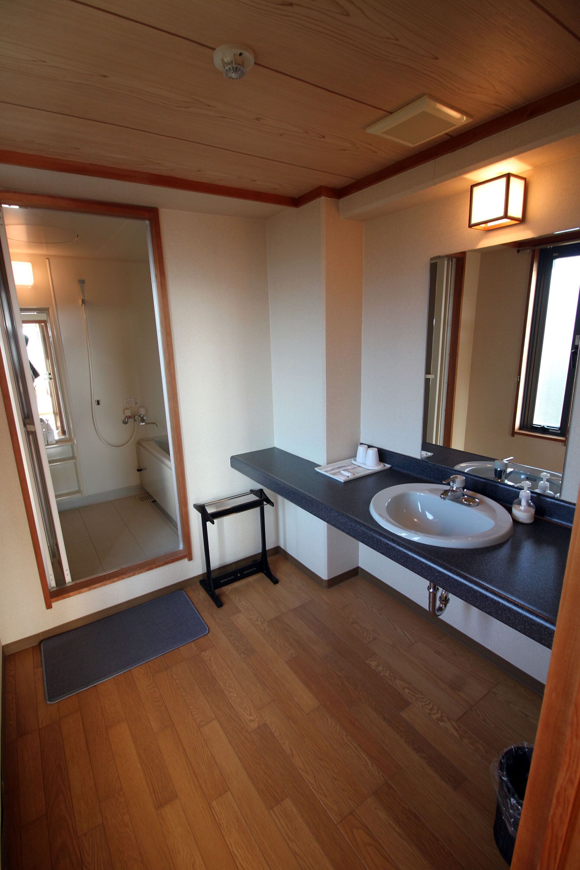 deluxe japanese style room for 4 guests | bathroom | hair dryer, slippers, electronic bidet, towels