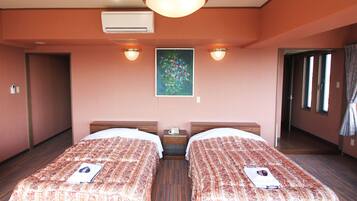 A hotel room with two beds, a nightstand, a painting on the wall, and an air conditioning unit.