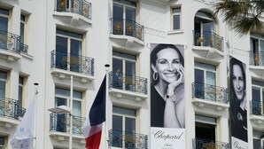 A hotel with multiple balconies, flags, and large posters. - Villa with terraces and swimming pool panoramic view. Near golf courses and beach, 1km from village (Valbonne)