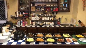 A buffet setup with various food items and kitchenware. - Nuowei Senlin Cottage (Ren'ai)