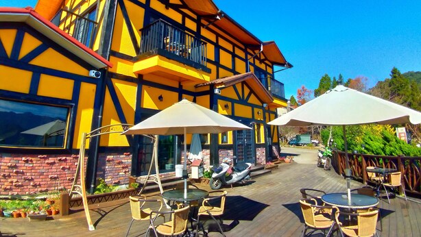 A traditional building with a balcony and outdoor seating area. - Nuowei Senlin Cottage (Ren'ai)