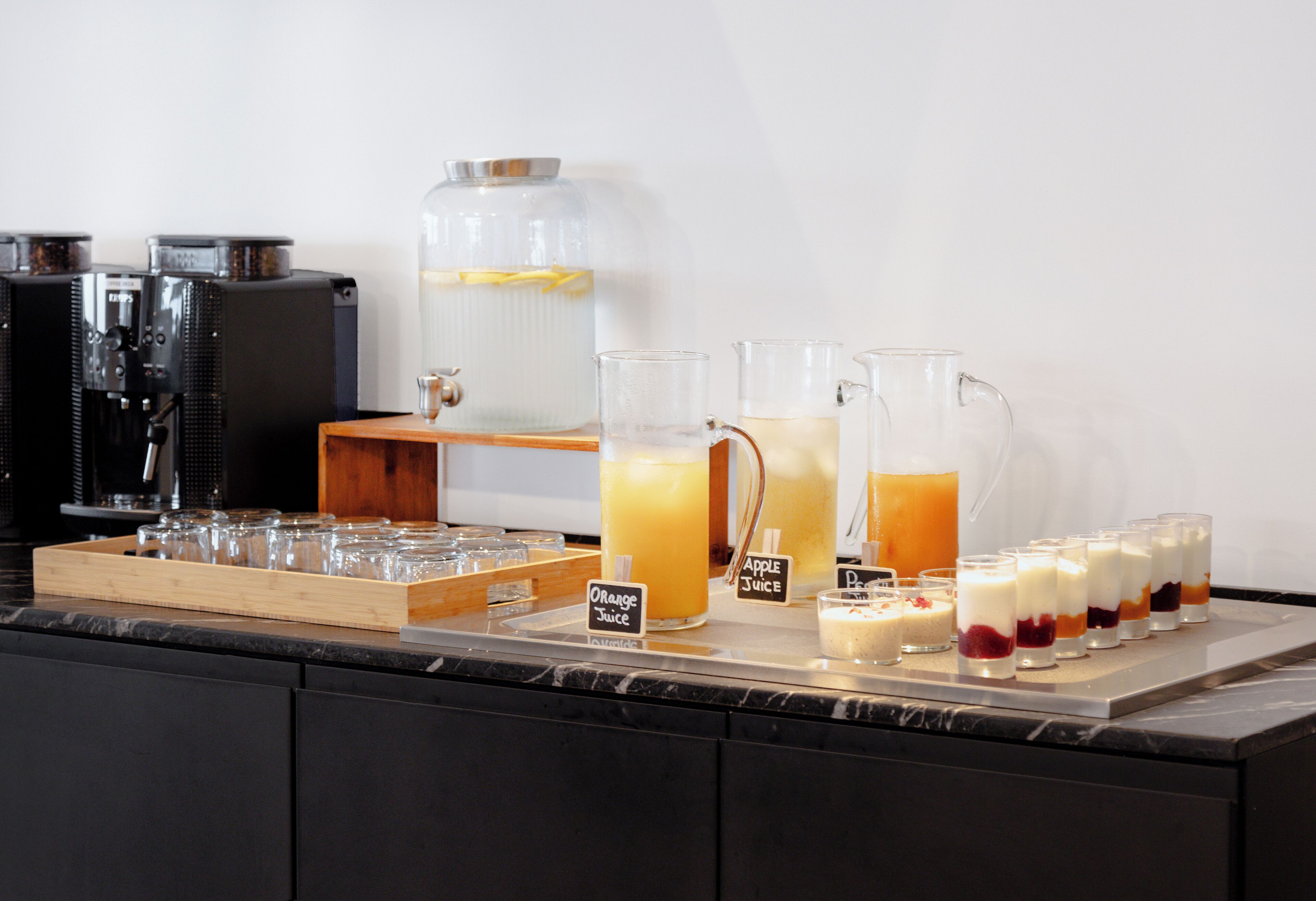 A beverage station with various drinks and a coffee machine.