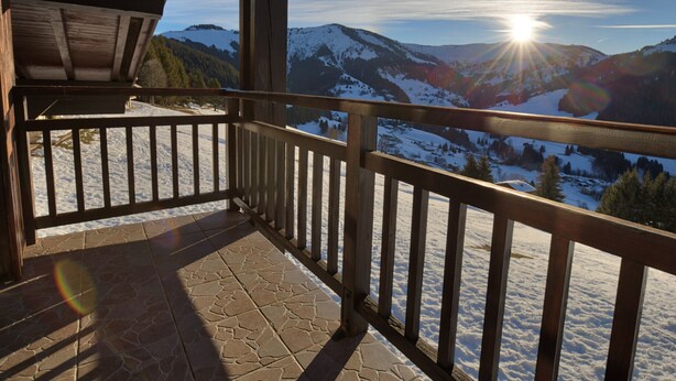 A wooden balcony with a stone floor, overlooking a snowy mountain landscape with the sun shining. - Quiet apartment near slopes, 6 ppl, parking (Notre-Dame-de-Bellecombe)