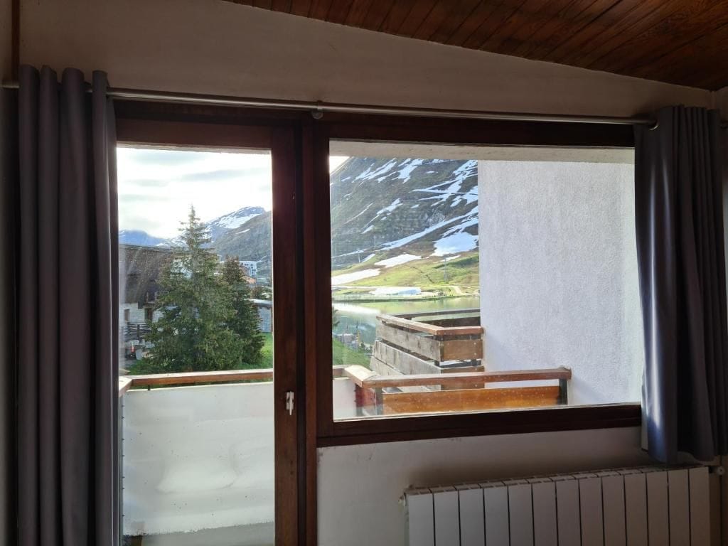 A room with a view of mountains and a river.