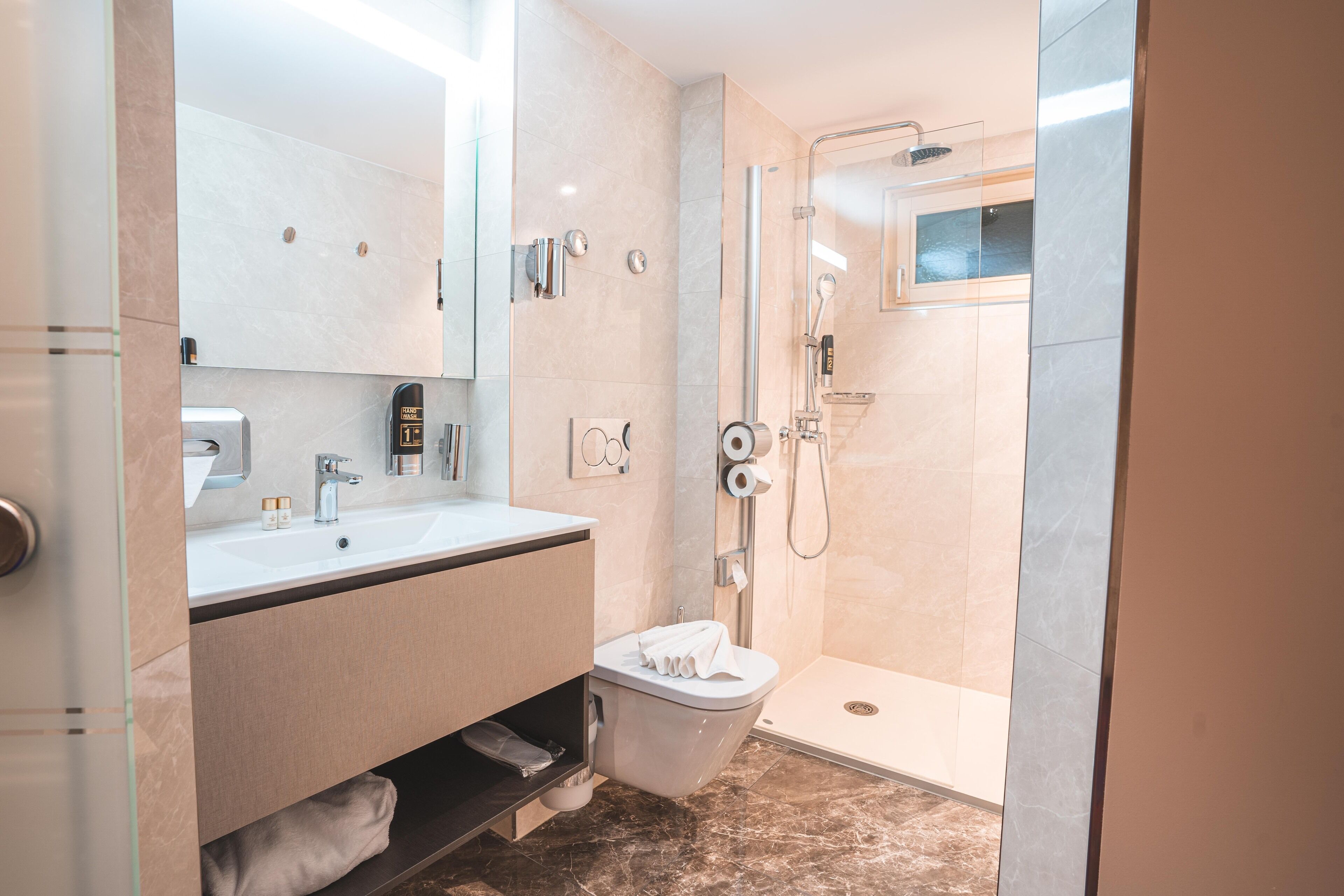 shower, rainfall showerhead, hair dryer, towels