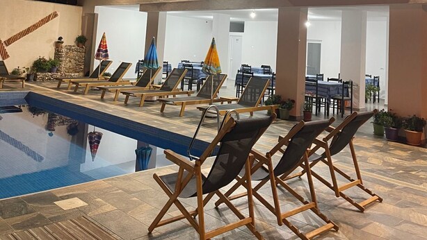 A hotel with a swimming pool, sun loungers, and a sign reading "HOTEL SEADEL". - Hotel Seadel (Ksamil)