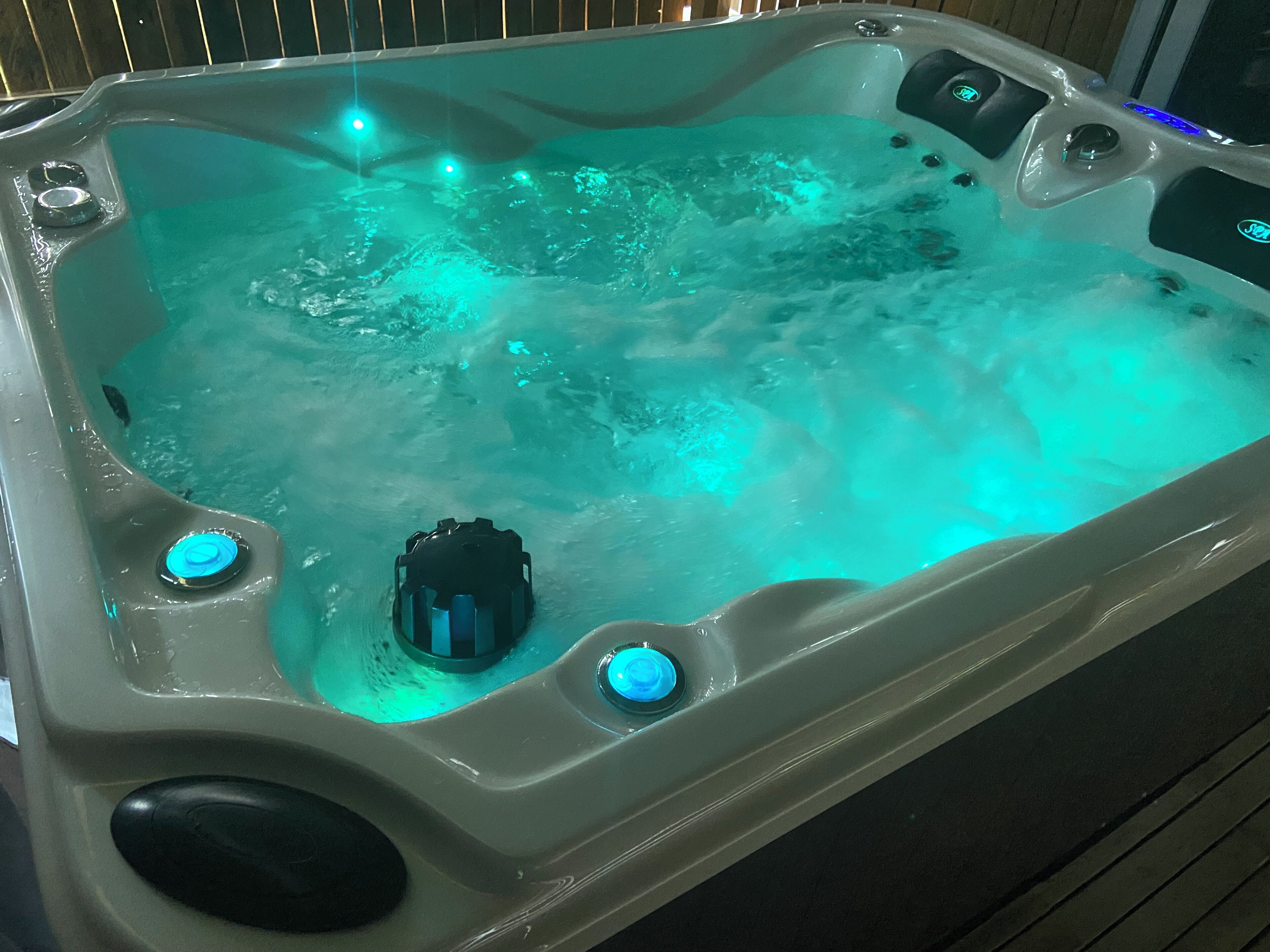 A hot tub with a control panel and jets.