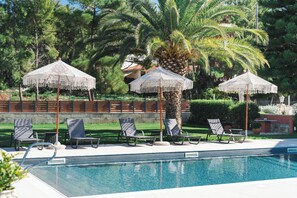 Seasonal outdoor pool, open 9:00 AM to 10:00 PM, pool umbrellas
