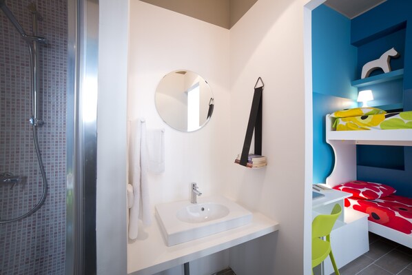 A bathroom with a shower, a sink, a mirror, and a bed with a nightstand. - Dreams Hotel Residenza De Marchi (Milan)