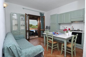 Apartment, 1 Bedroom | Private kitchen | Fridge, stovetop, highchair, cookware/dishes/utensils - Appartamenti Il Faro (San Teodoro)
