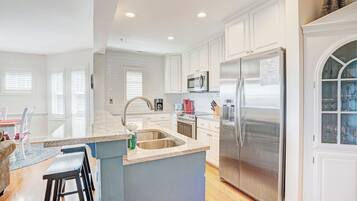 Dishwasher, coffee/tea maker, cookware/dishes/utensils, dining tables