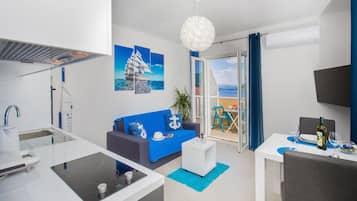 Deluxe Apartment, Balcony, Sea View | Living room | 42-inch LED TV with satellite channels, TV, heated floors