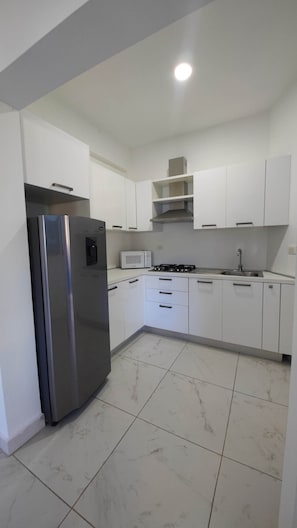 Fridge, microwave, stovetop, coffee/tea maker