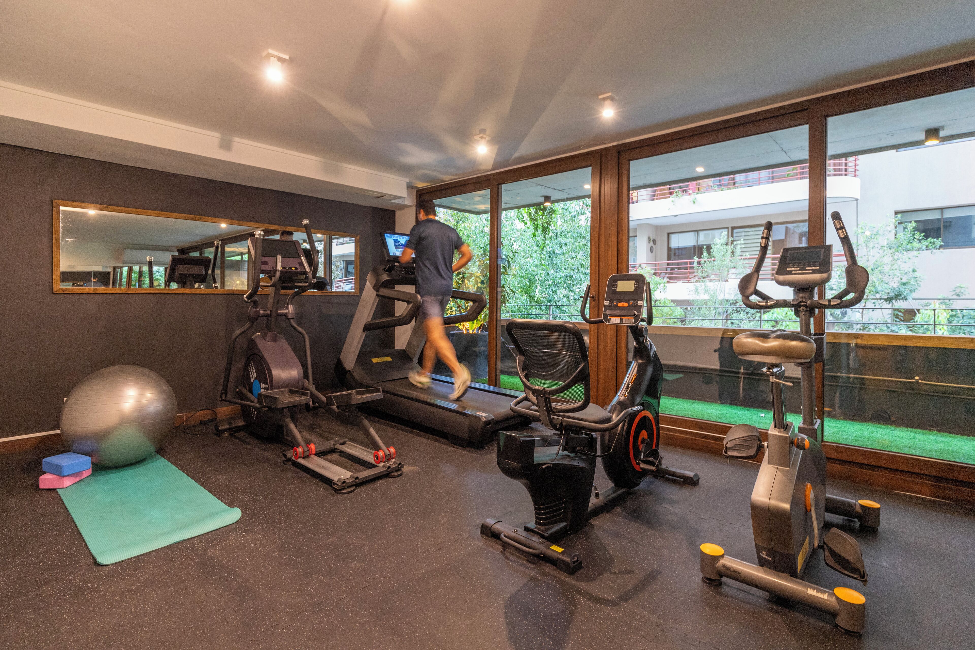 A gym with treadmills, an elliptical, and a stationary bike.