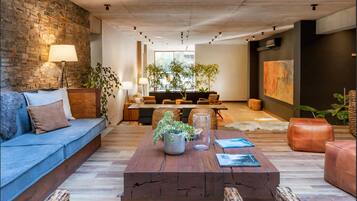 A modern living room with a sofa, coffee table, and dining area.
