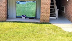 A building entrance with a brick facade, a set of stairs leading to a door, and a small flower box on the steps. - Cozy  2bdr. Condo in Central Raleigh (Raleigh)