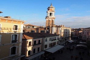 A historic square with traditional buildings and a prominent tower.