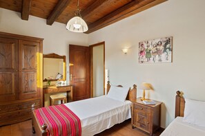 A bedroom with a wooden bed, a nightstand, a dresser, and a mirror. - Villa Maza, beautiful stone villa in traditional village Maza, Chania (Maza)