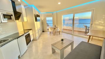 Appartement Supérieur, vue mer, en bord de plage | Salle de séjour | Télévision à écran plat de 42 pouces avec chaßnes numériques, télévision